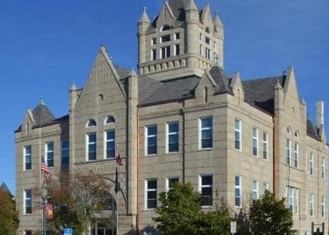 A historic stone county courthouse with a clock tower