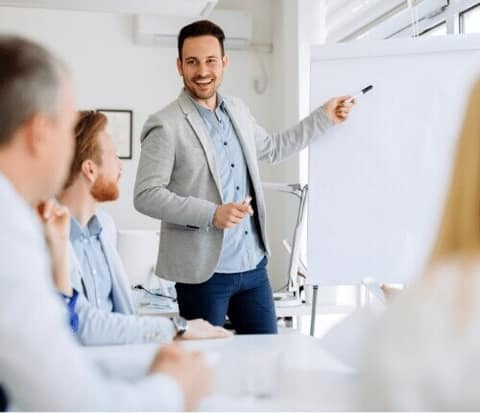 A presenter at a whiteboard leading a planning session